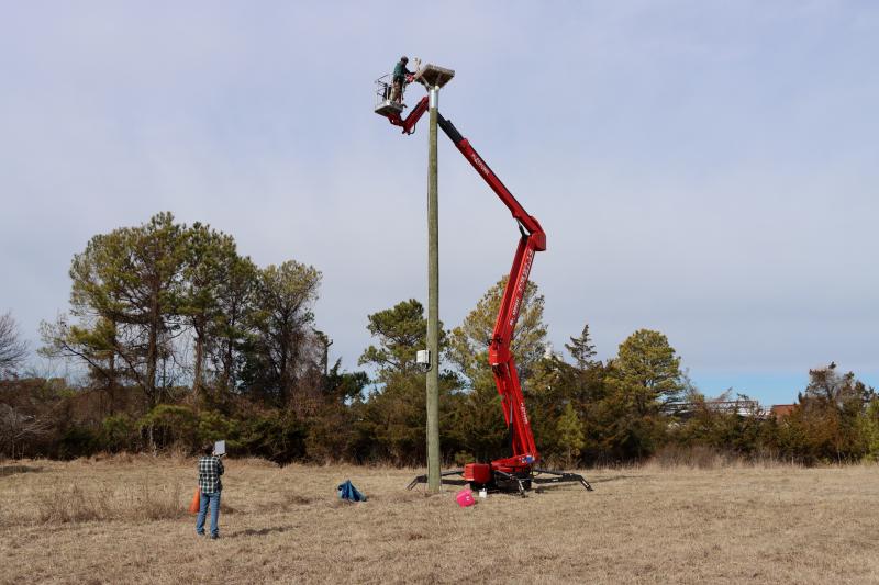Jodi McLaughlin, left, monitors the livestream while Dan Baker is working on the camera platform 45 feet in the air. BILL SHULL PHOTO